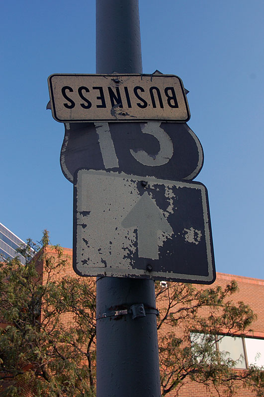 Wind and other elements over time turned the shield assembly 90 degrees so that it faced the sidewalk before the signs were ultimately removed.