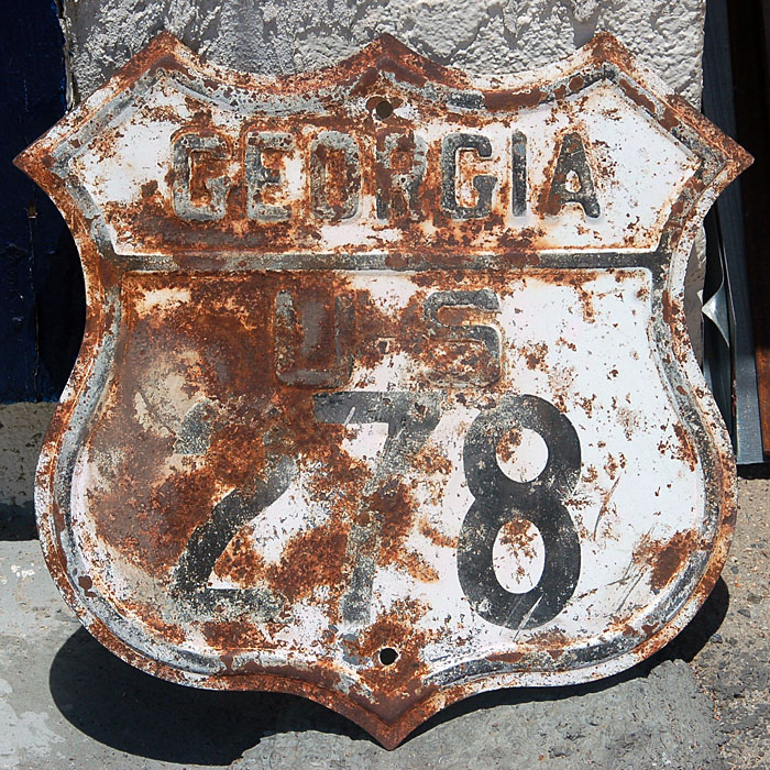 An older blank, with newer font style. This sign was stamped out in the 1940s, and printed in 1959.