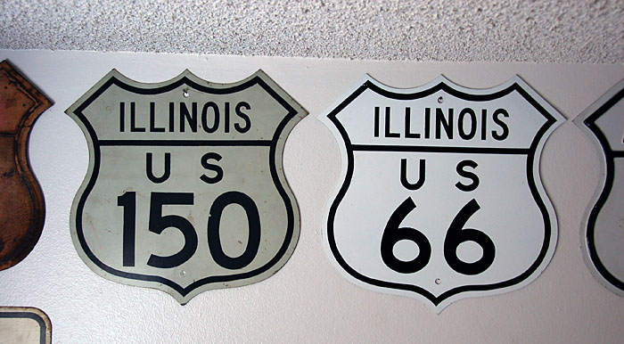 The 150 is a genuine shield. The 66 is a replica, issued by the Illinois highway department in 1975 when the route was decommissioned. These replicas were all non-reflective.