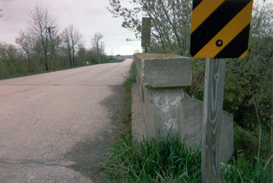 This route 42 marker survives, painted onto the side of a bridge, over 80 years after it was originally placed.